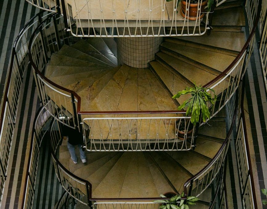 high angle view of a spiral staircase and striped balconies